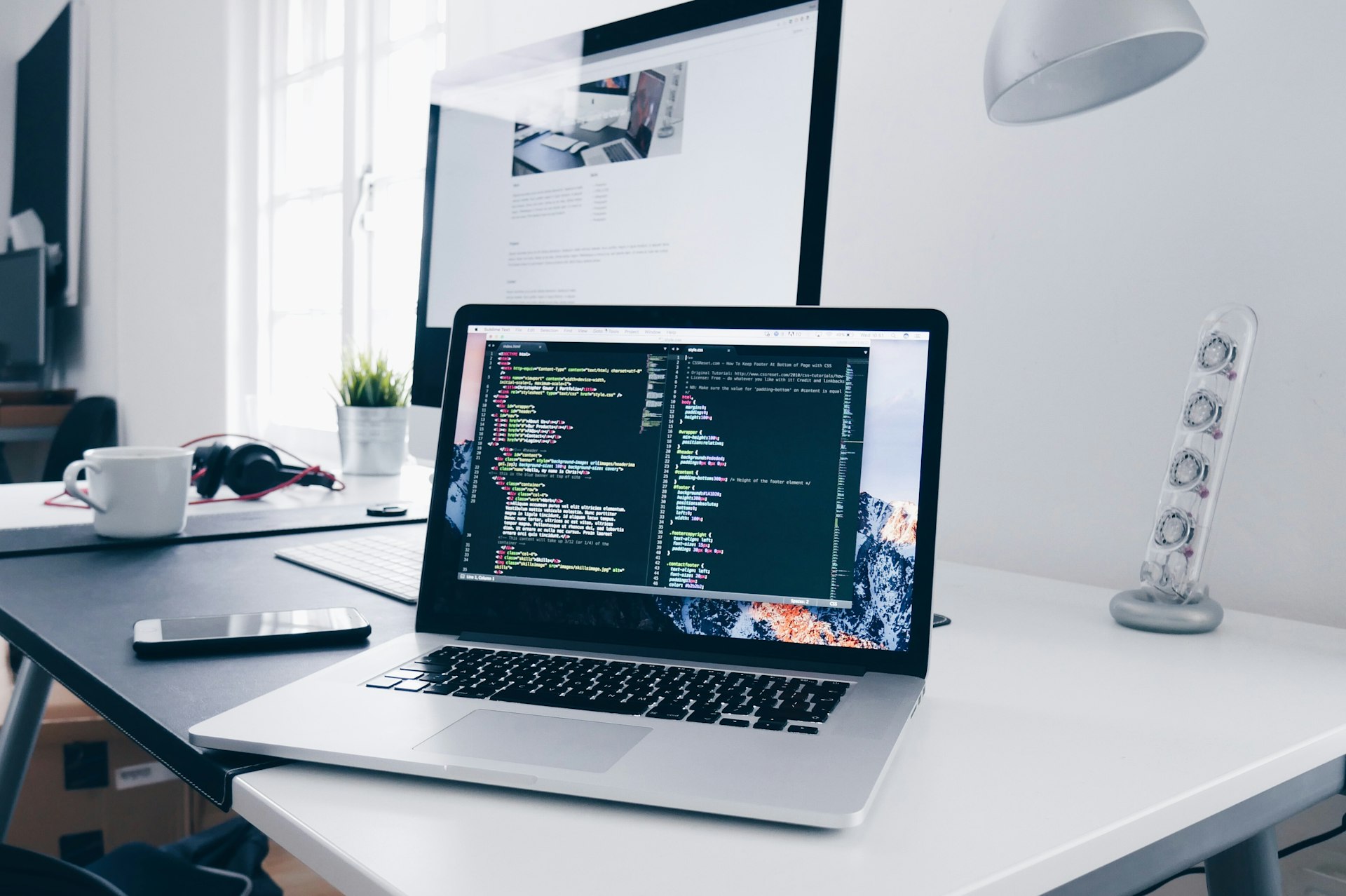 Developer reviewing code at a clean desk setup